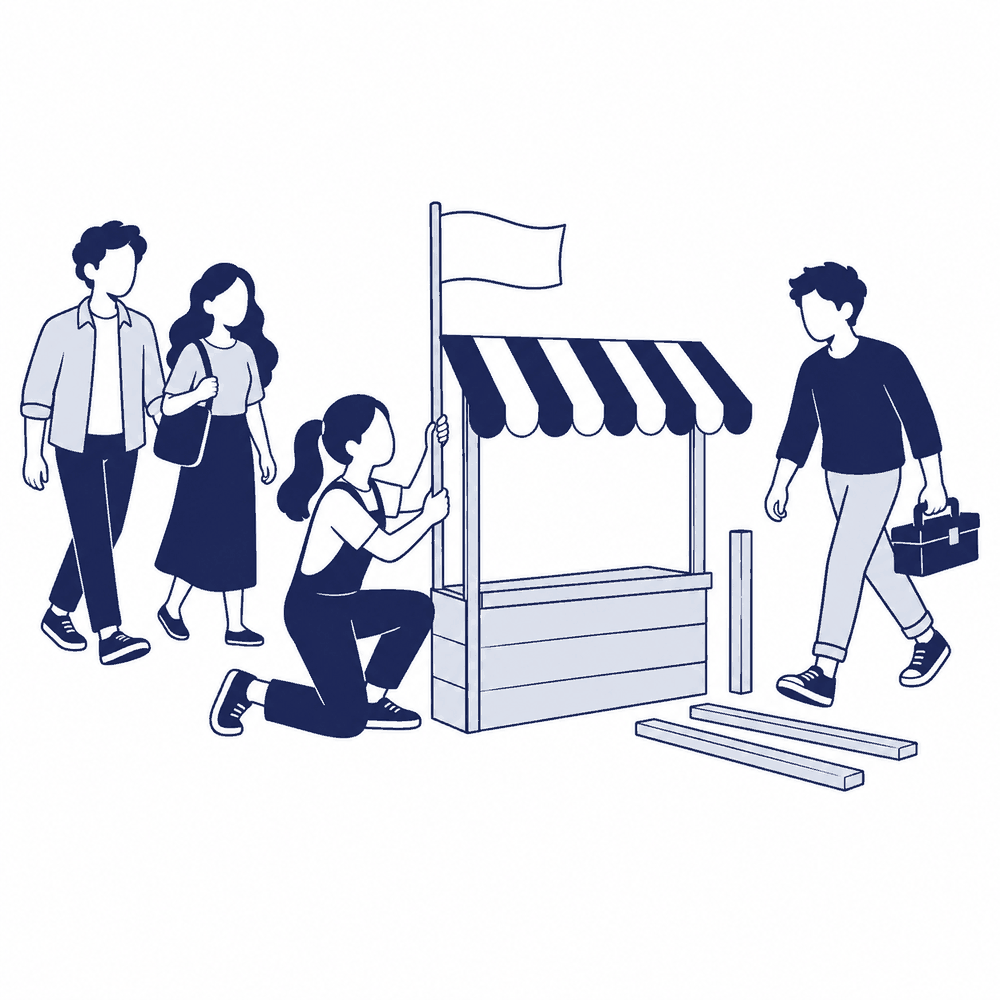 空き地に旗を立てて最初の店を組み立てる人と、道具を持って隣に店を建てに来る人、様子を見に来る2人
